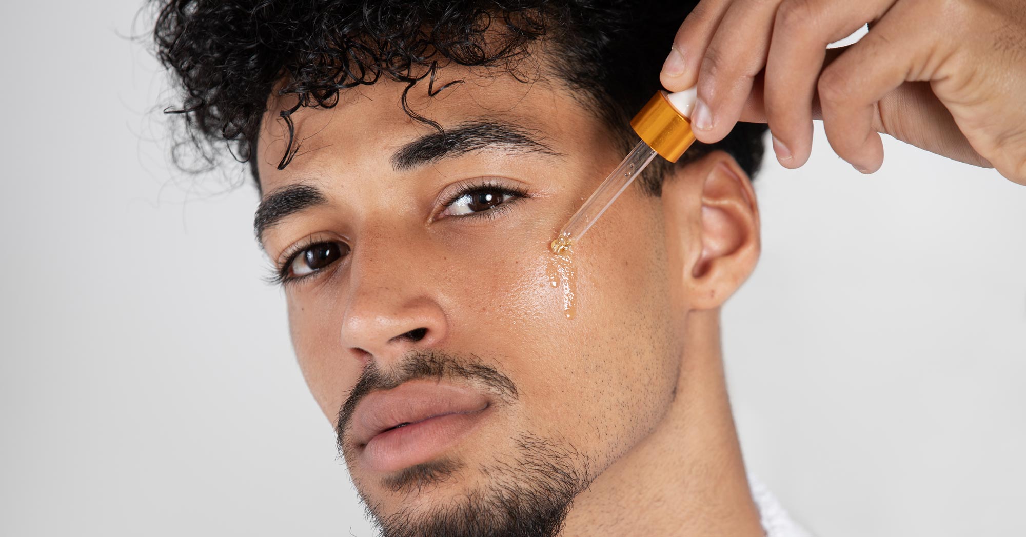 Man Applying Serum To His Face