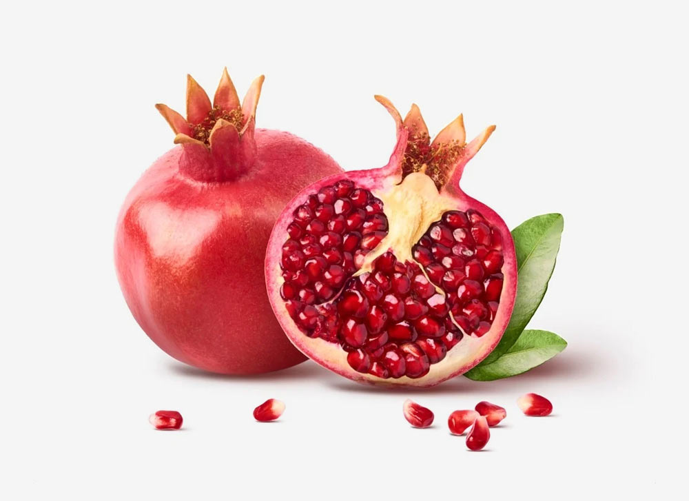 Pomegranate Cut In Half With Seeds Around